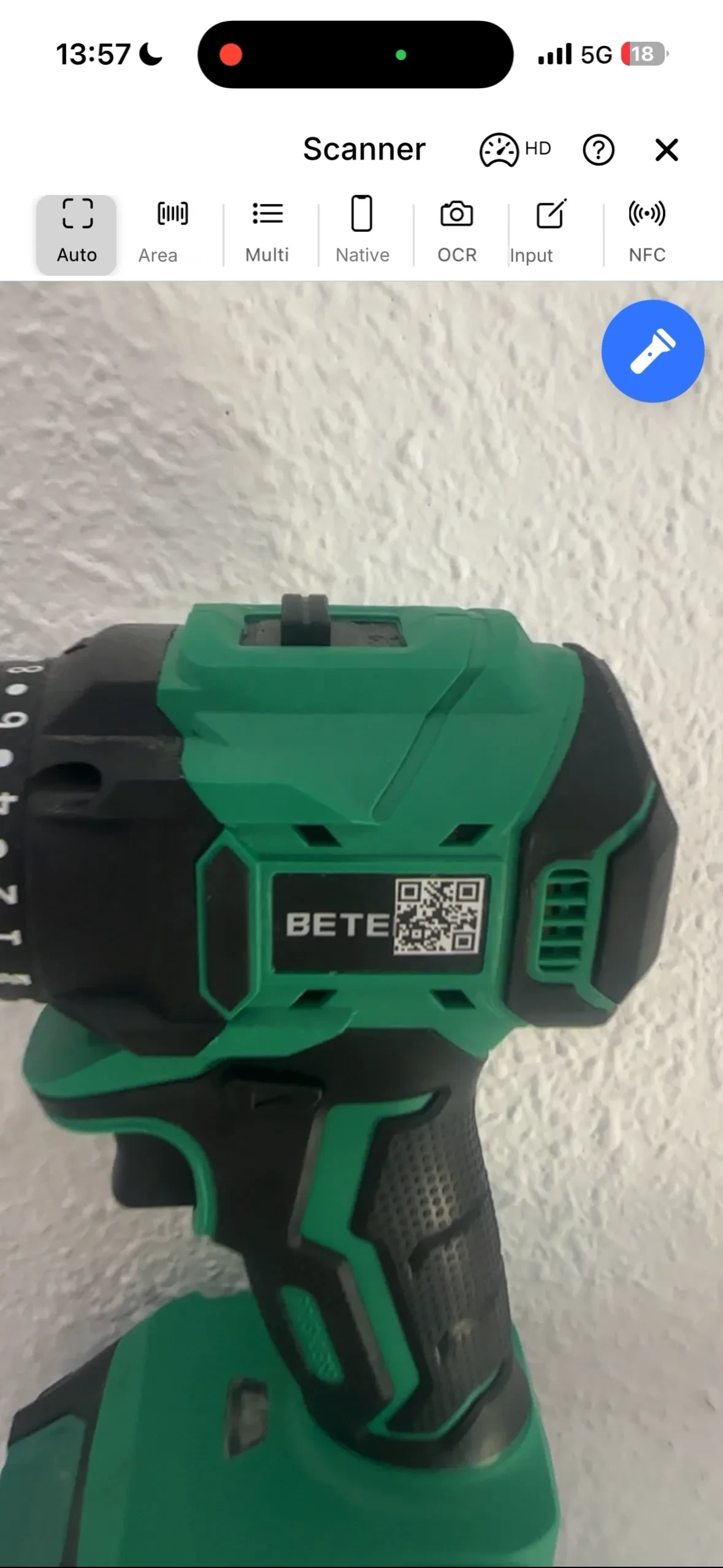 The scanner screen in the mobile app pointed at the QR code on a drill