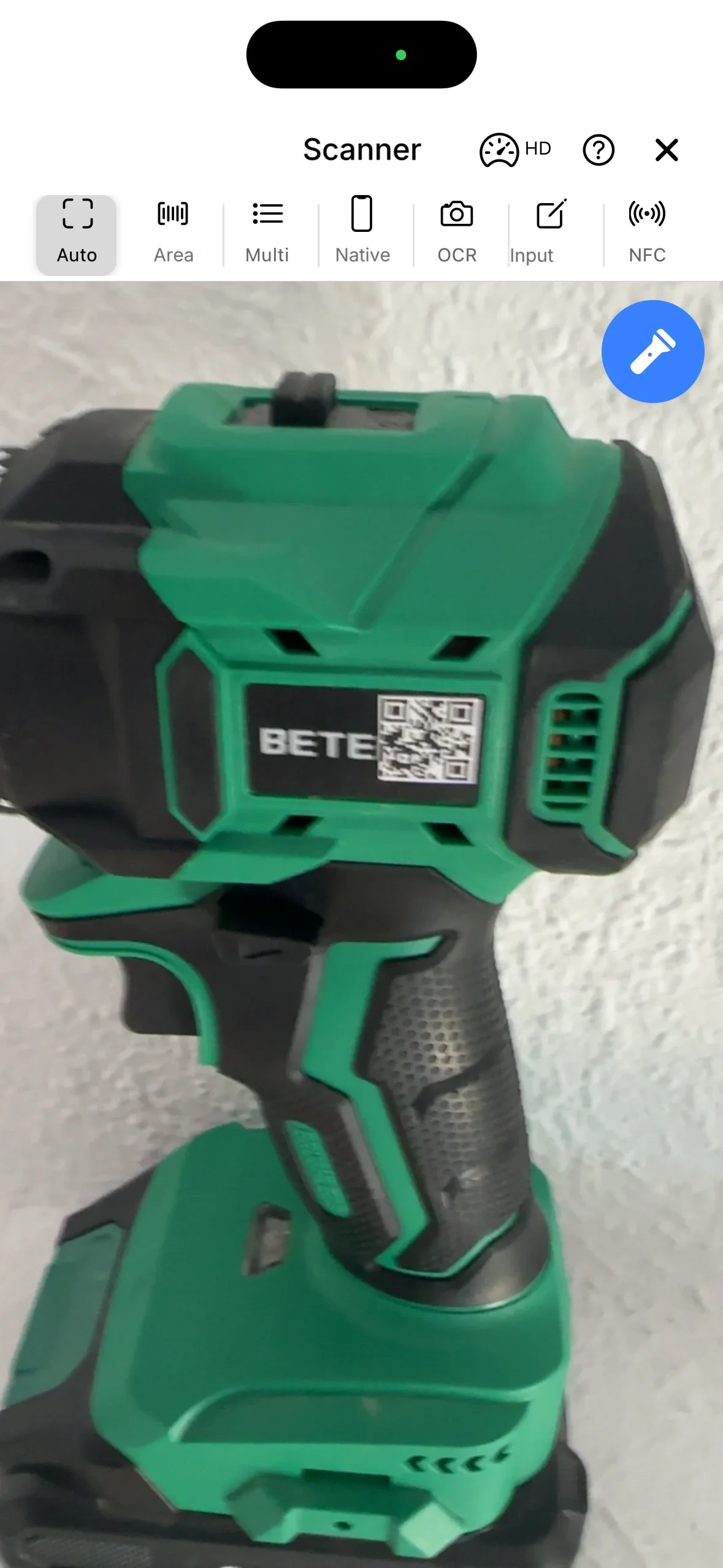The scanner in the mobile app reading the code on a drill